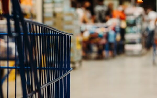 Supermarket aisle with shopping cart