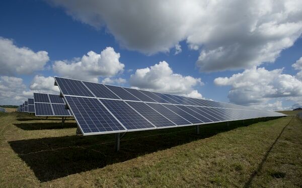 Solar panel farm under cloudy sky