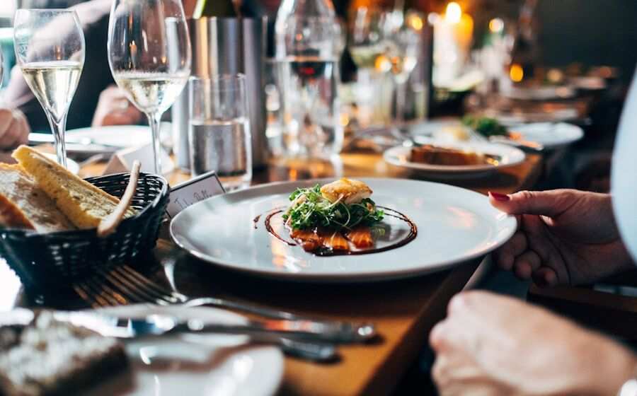 Upscale fine-dining restaurant table with plated dish and wine