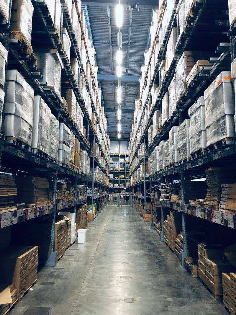 Wholesale and cash-and-carry &mdash; stacked pallets and warehouse operations powering